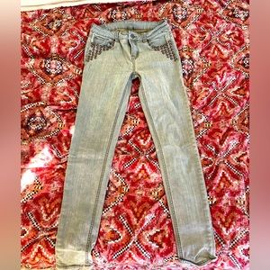 Khaki green skinny jeans with brass studded detail